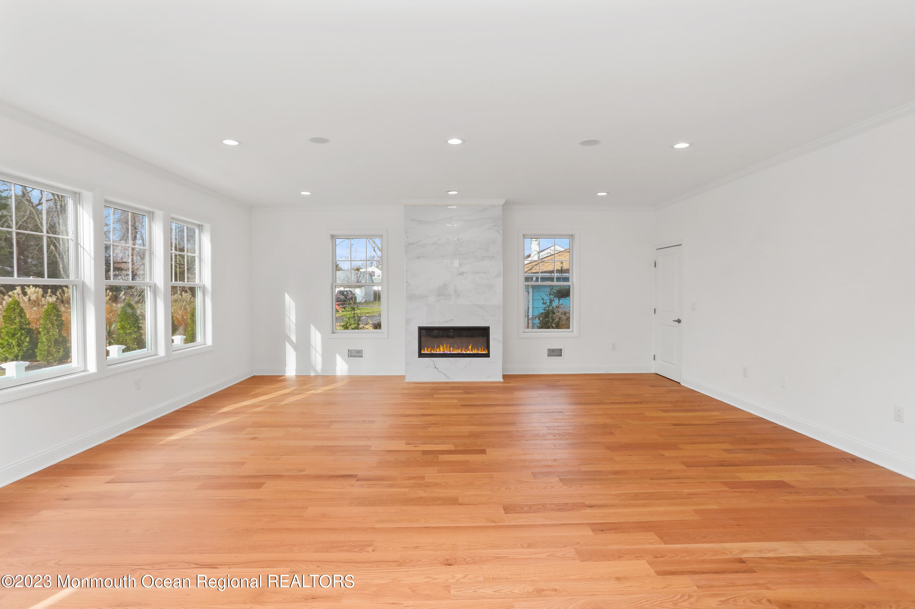 2223 Old Mill Road Spring Lake Heights, NJ 07762 - Photo 6 of 74 a view of empty room with wooden floor and fireplace