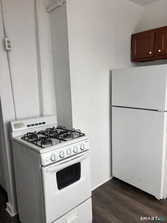 a stove top oven sitting inside of a kitchen