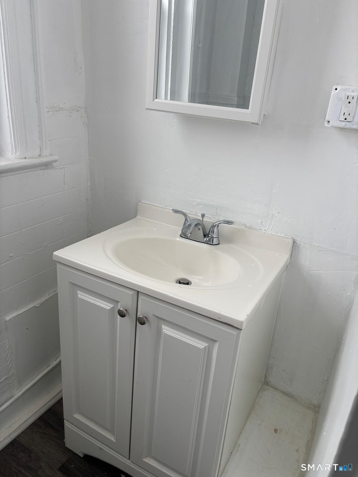 86 Pequonnock Street, Unit 56 Bridgeport, CT 06604 - Photo 4 of 5 a bathroom with a sink and cabinets