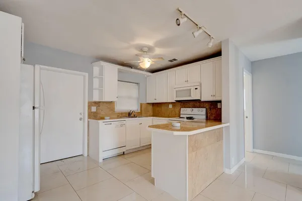 a view of a kitchen with electric appliances