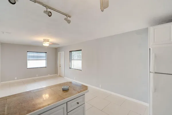 a view of empty room with window and wooden floor