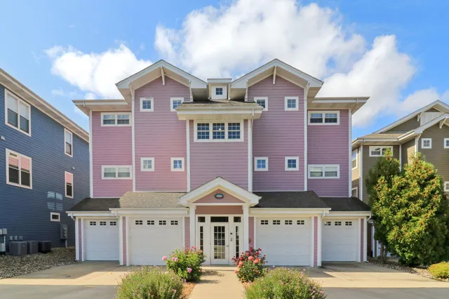 a front view of residential houses with yard