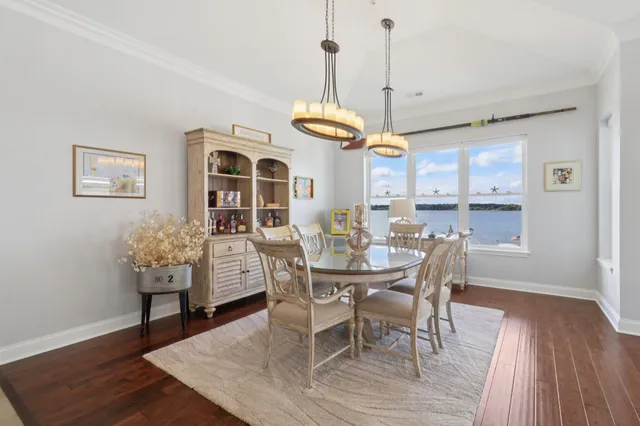 a dining room with furniture a chandelier and wooden floor
