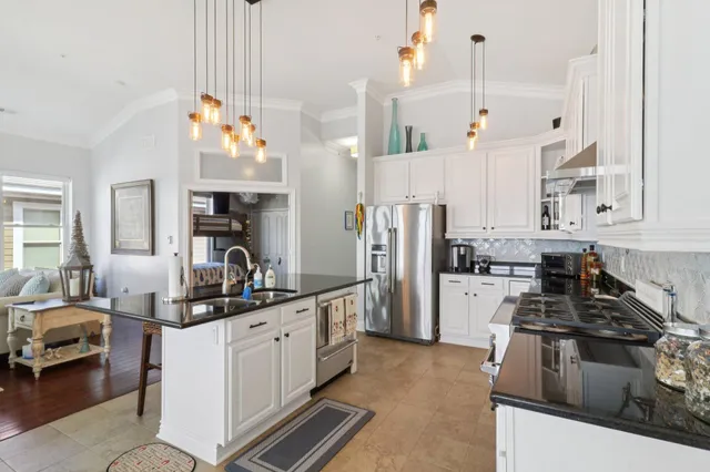 a kitchen with refrigerator a stove and a sink