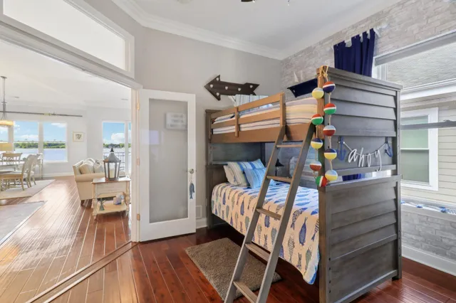 a bedroom with furniture and a wooden floor