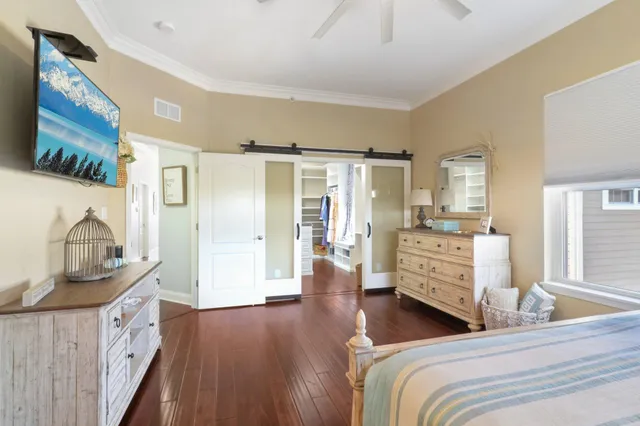a bedroom with furniture and wooden floor