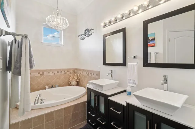 a bathroom with a sink a mirror and a bathtub