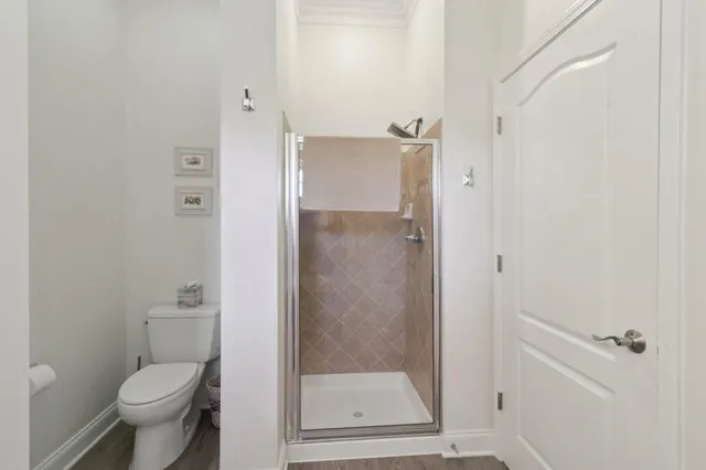 a bathroom with a granite countertop toilet and a shower