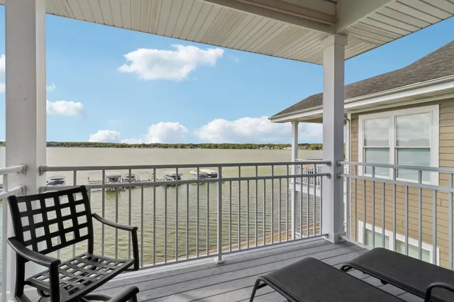 a view of a chairs and table in the balcony