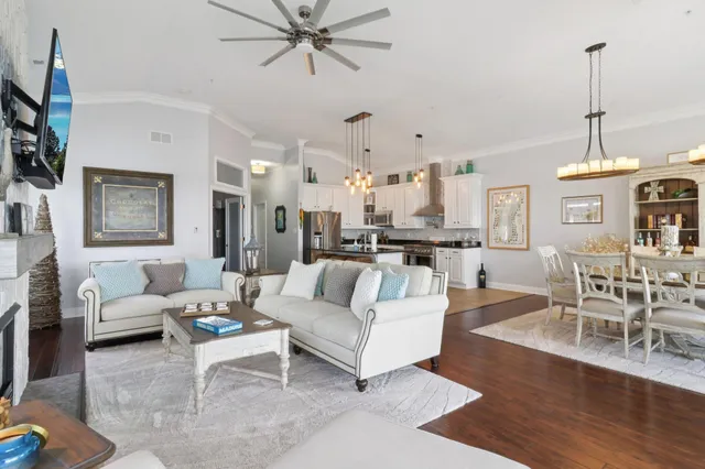 a living room with furniture and a chandelier