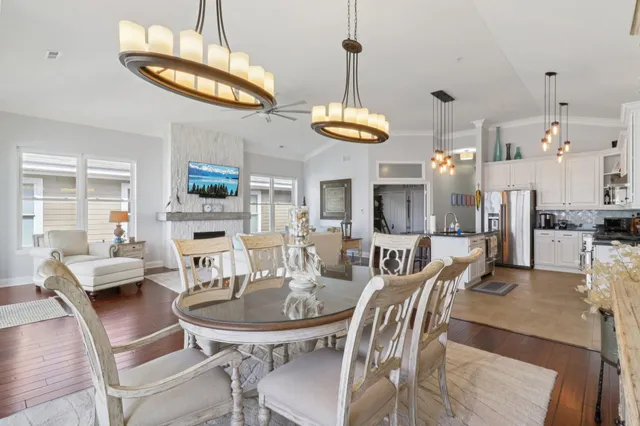 a view of a dining room with furniture a chandelier and wooden floor