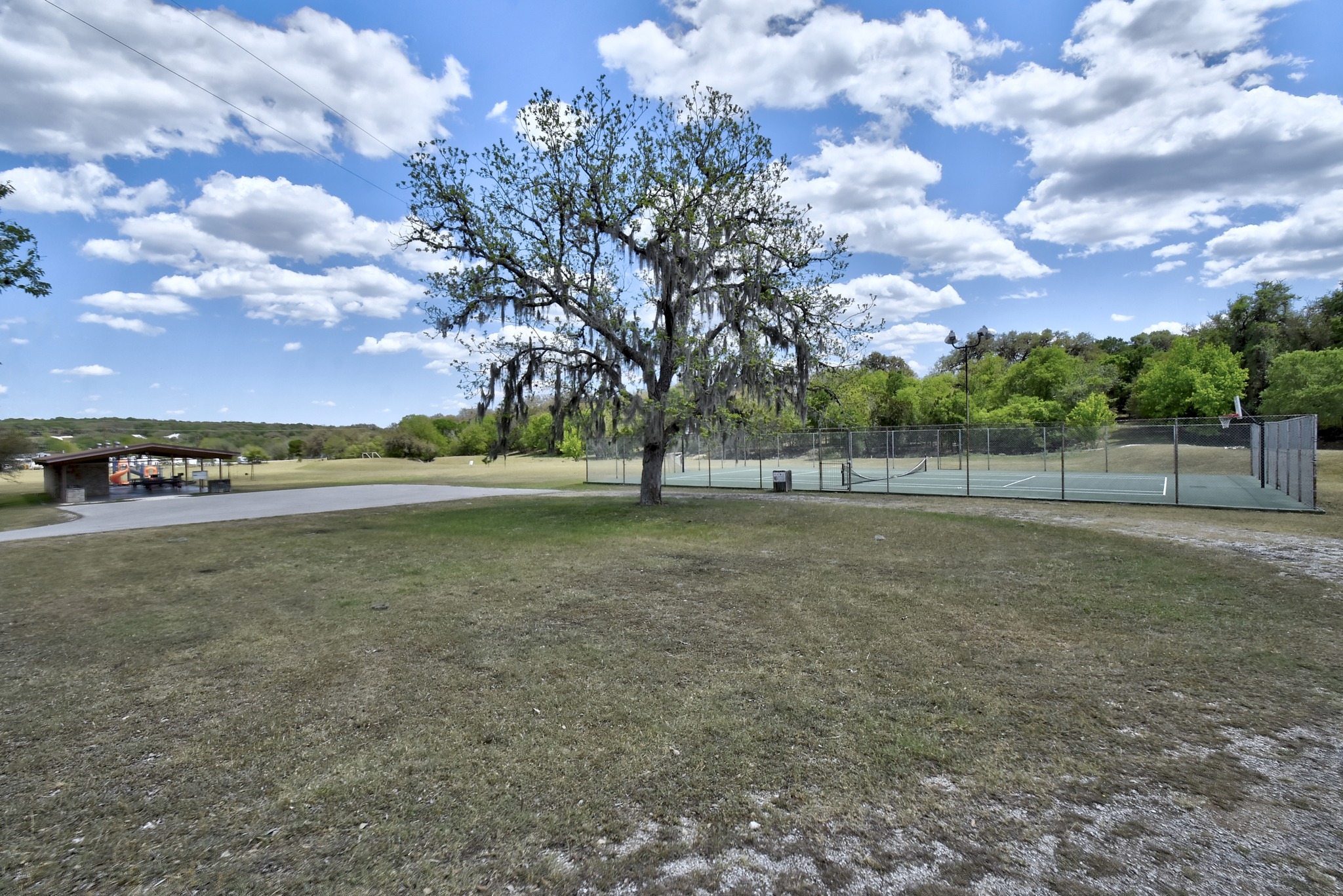 1170 Misty Lane Spring Branch, TX 78070 - Photo 20 of 24 A sprawling green space with mature trees offers recreation with a well-maintained tennis court.