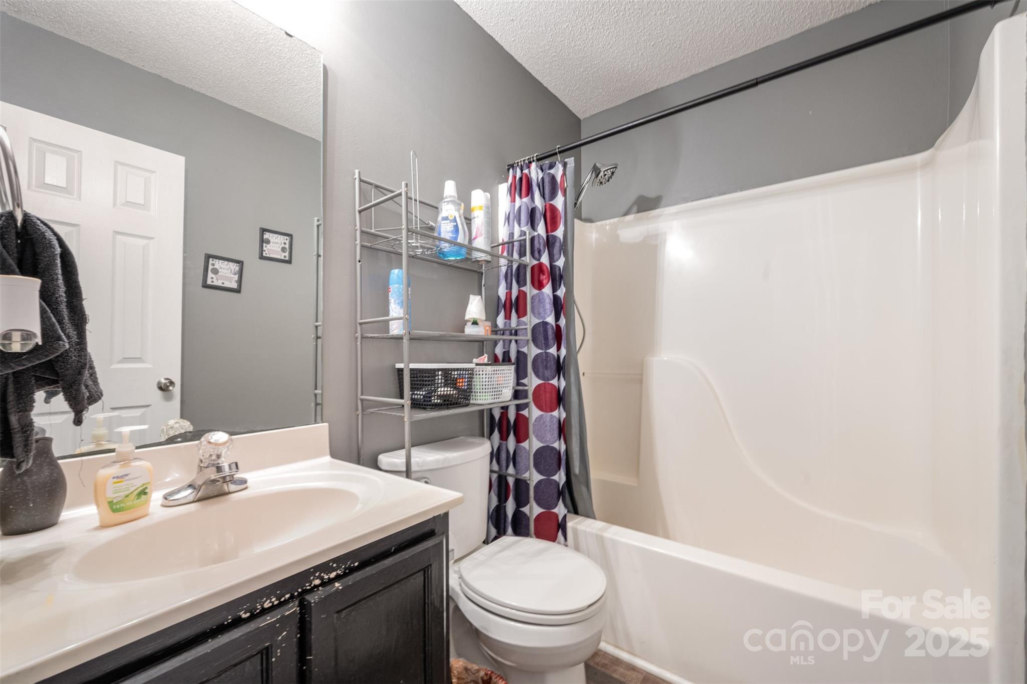 704 Willow Road Salisbury, NC 28147 - Photo 14 of 18 a bathroom with a sink toilet vanity and shower