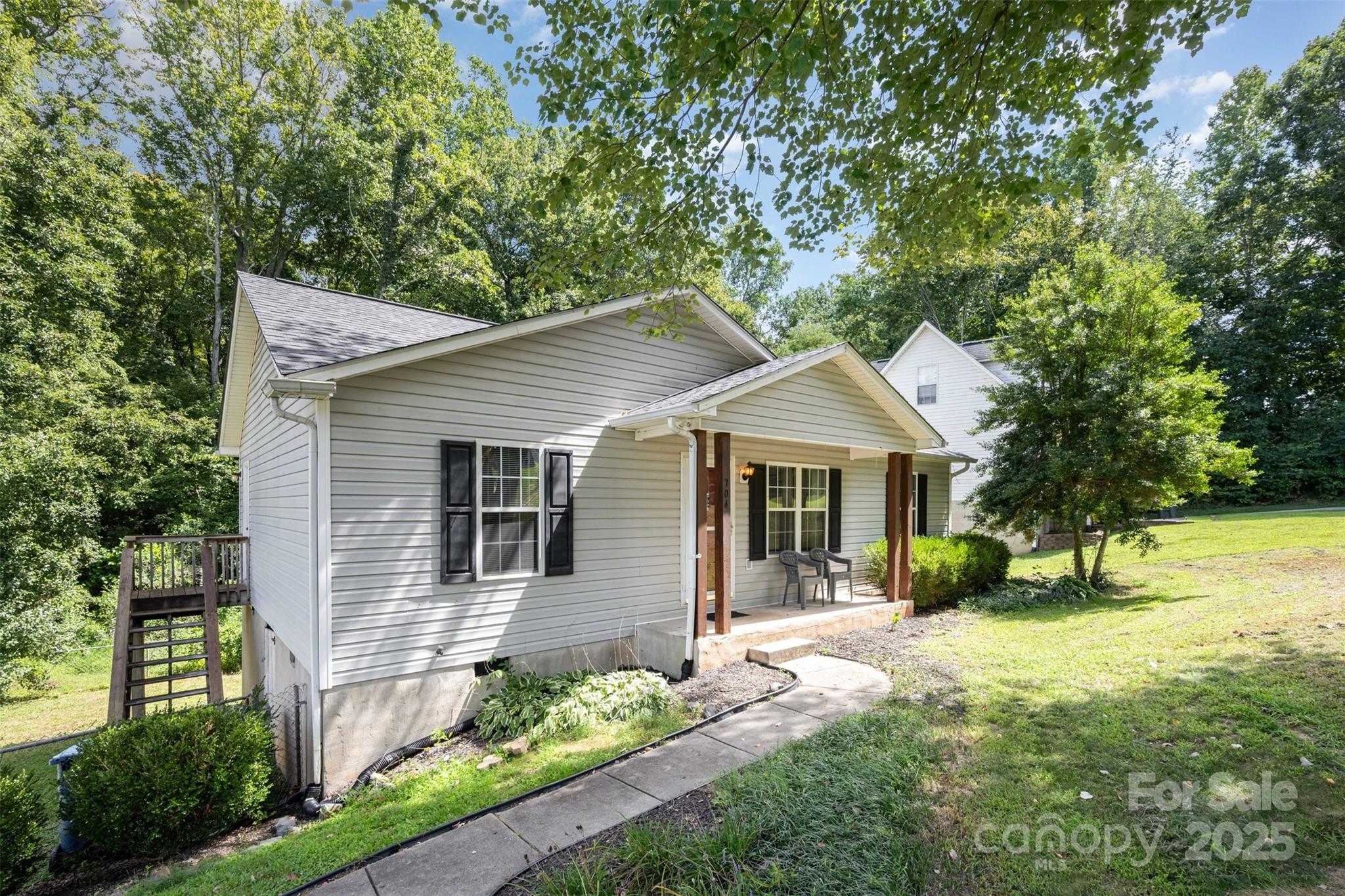 704 Willow Road Salisbury, NC 28147 - Photo 15 of 18 a front view of a house with a yard and potted plants