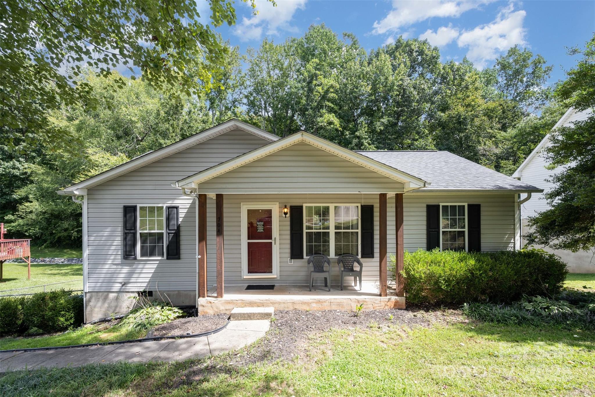 704 Willow Road Salisbury, NC 28147 - Photo 17 of 18 a front view of a house with a yard and potted plants