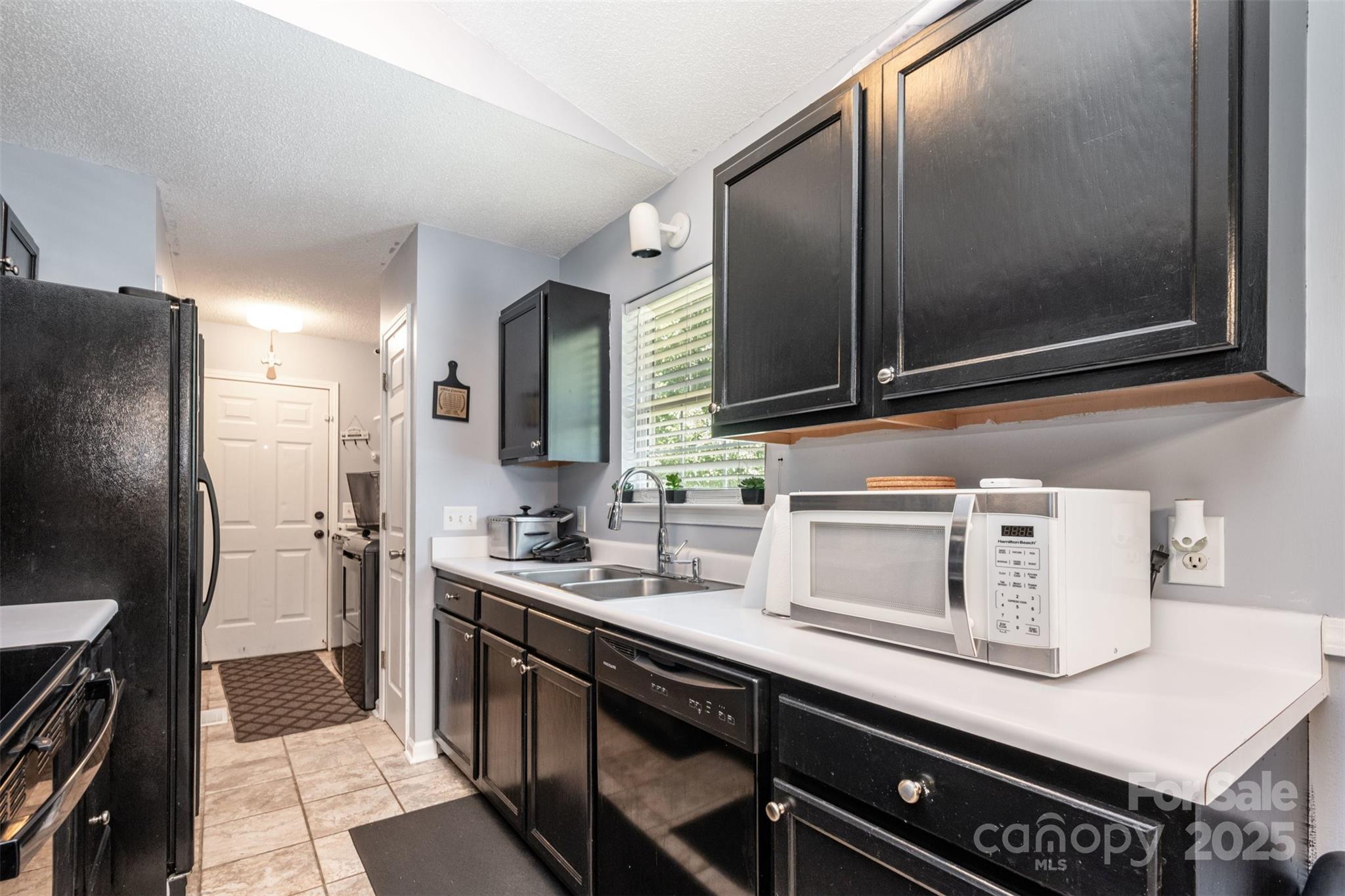 704 Willow Road Salisbury, NC 28147 - Photo 3 of 18 a kitchen with a sink and stainless steel appliances