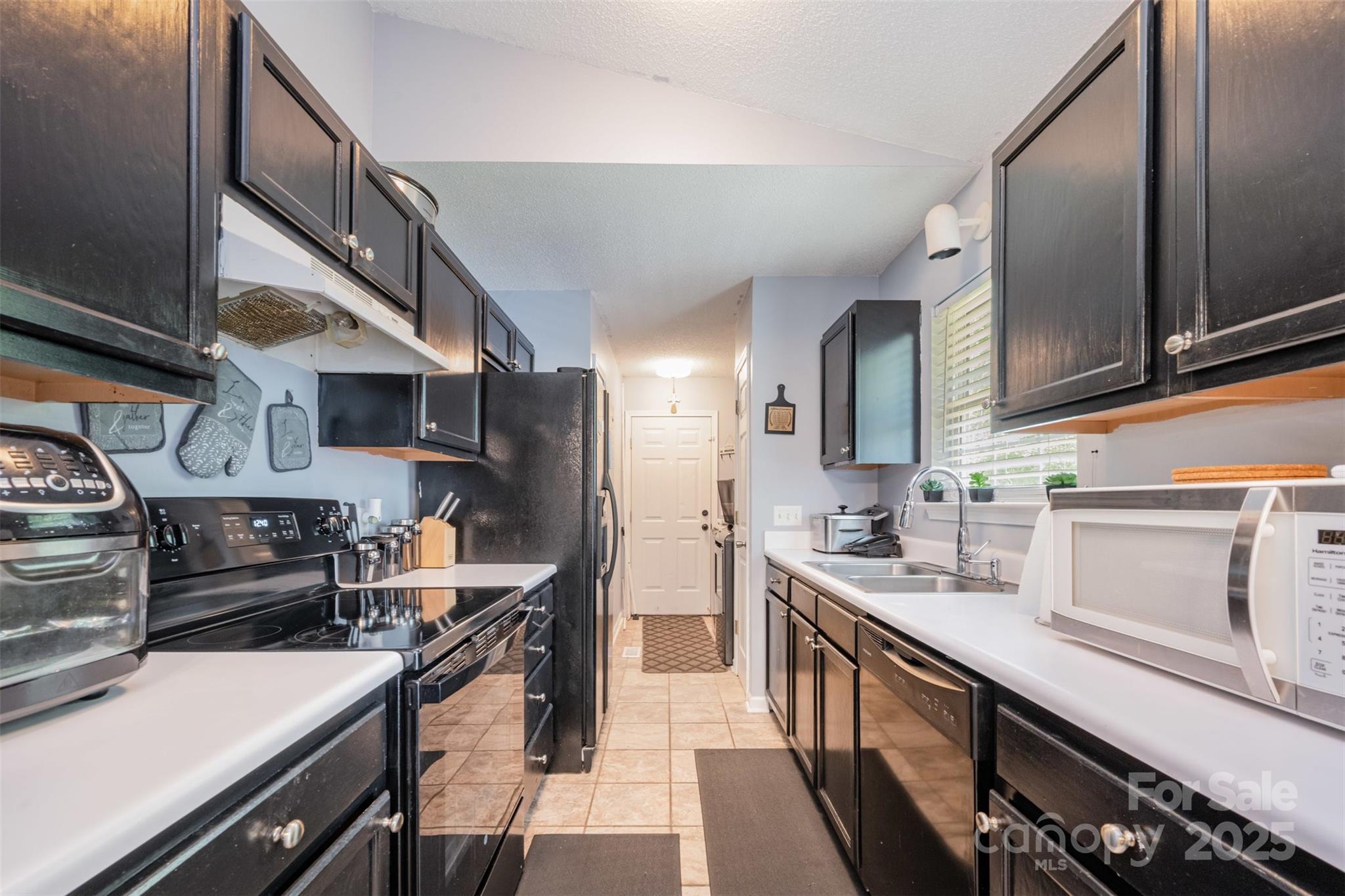 704 Willow Road Salisbury, NC 28147 - Photo 4 of 18 a kitchen with stainless steel appliances a sink stove and cabinets