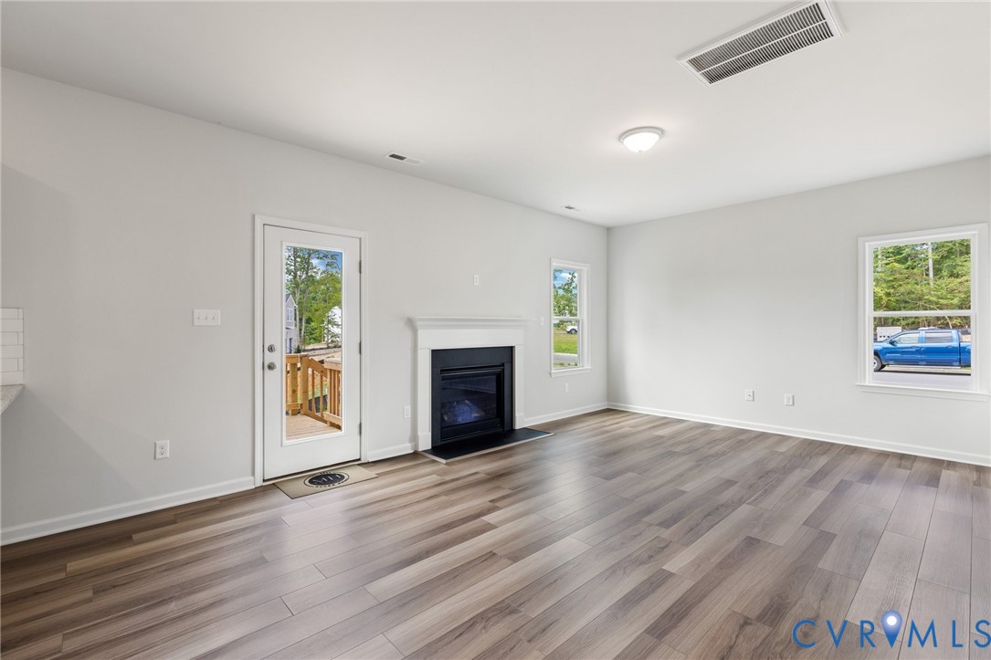 137 Bellevue Terrace Aylett, VA 23009 - Photo 11 of 24 an empty room with windows and a fireplace