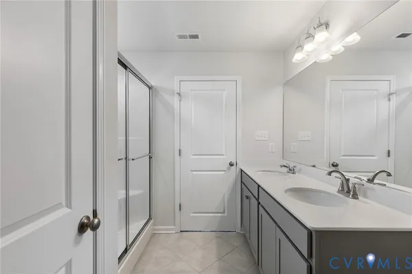 a bathroom with a sink double vanity and a mirror