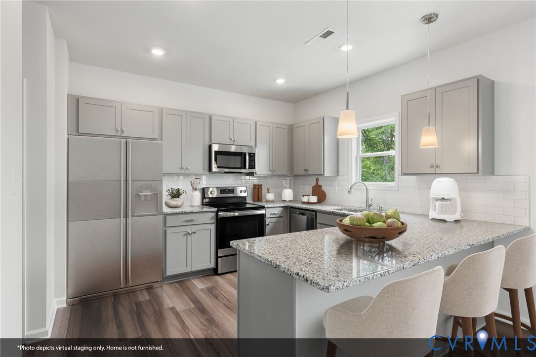 137 Bellevue Terrace Aylett, VA 23009 - Photo 3 of 24 a kitchen with stainless steel appliances granite countertop a sink dishwasher a stove refrigerator and cabinets with wooden floor