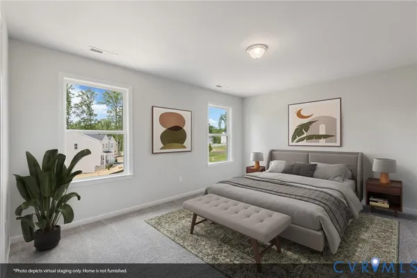 a bedroom with a bed and a painting on the wall