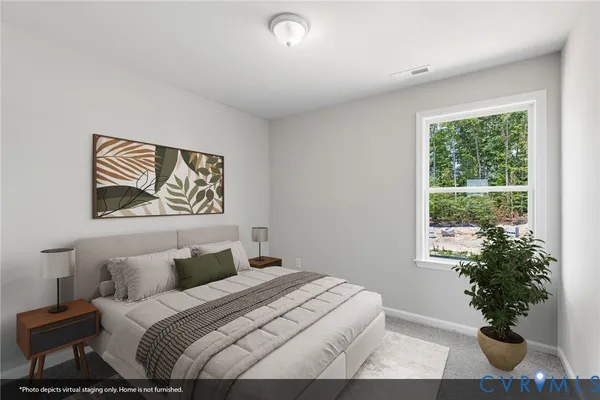 a bedroom with a large bed and a potted plant
