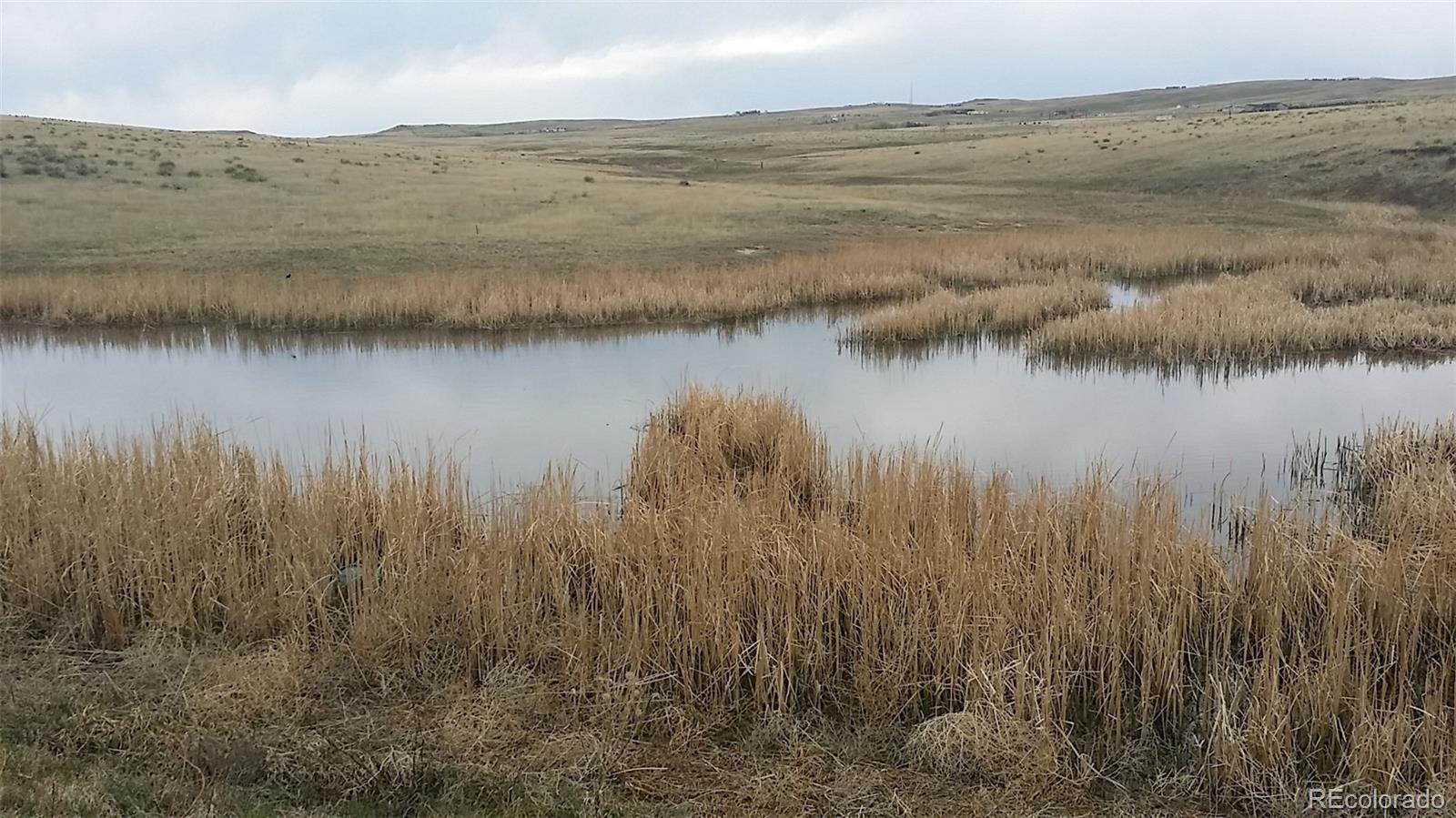 25800 Judge Orr Road Calhan, CO 80808 - Photo 2 of 18 a view of lake with mountain