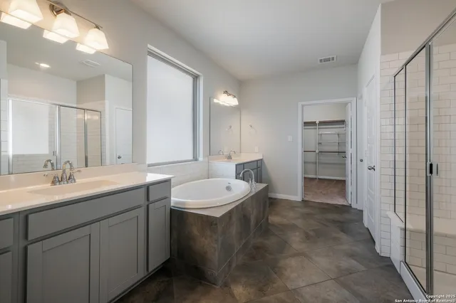 a spacious bathroom with a double vanity sink mirror and double