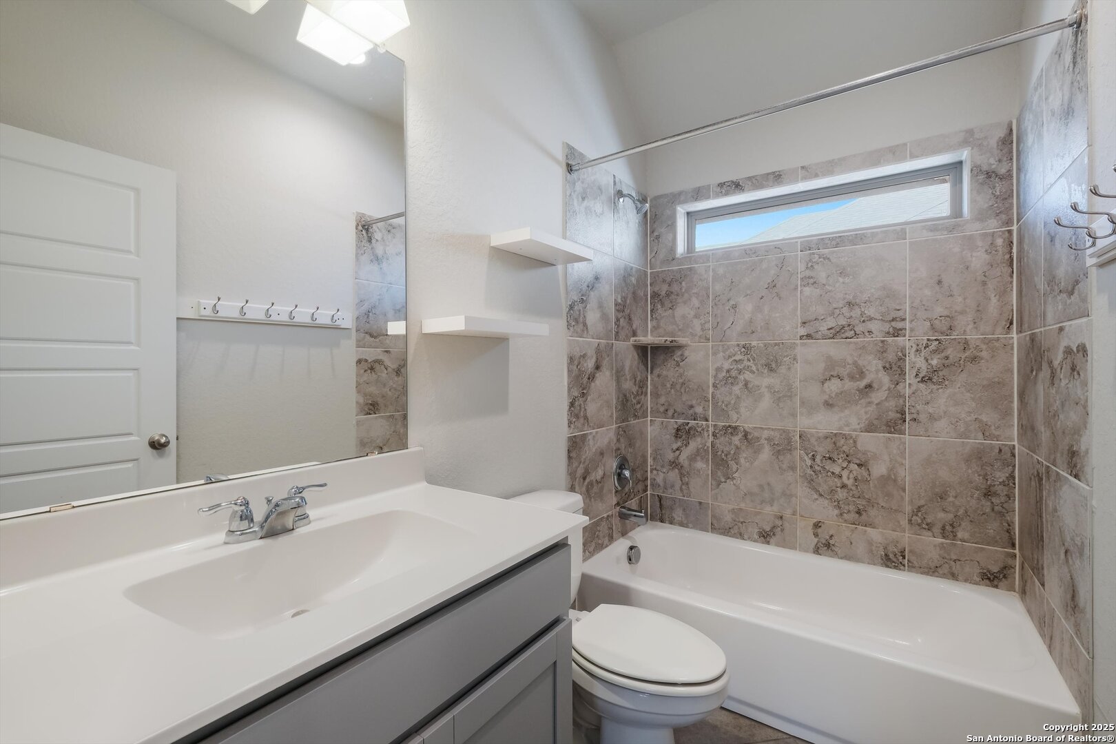 1718 Wind River San Antonio, TX 78258 - Photo 24 of 32 a bathroom with a granite countertop bathtub shower sink vanity mirror and toilet