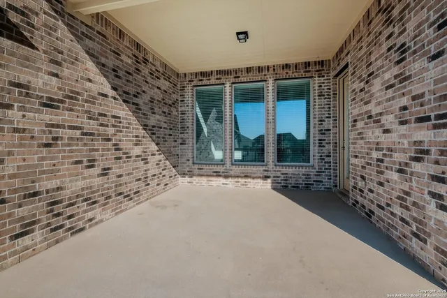a view of a brick house with large windows