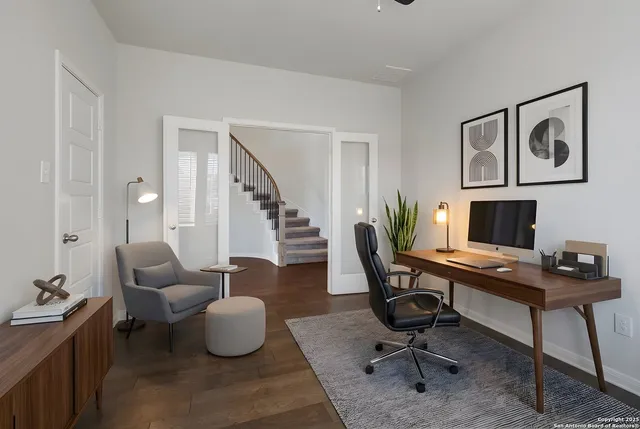 a view of a livingroom with workspace and a couch
