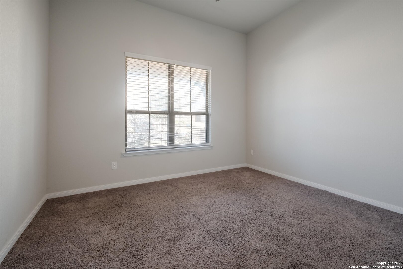 1718 Wind River San Antonio, TX 78258 - Photo 5 of 32 an empty room with a window