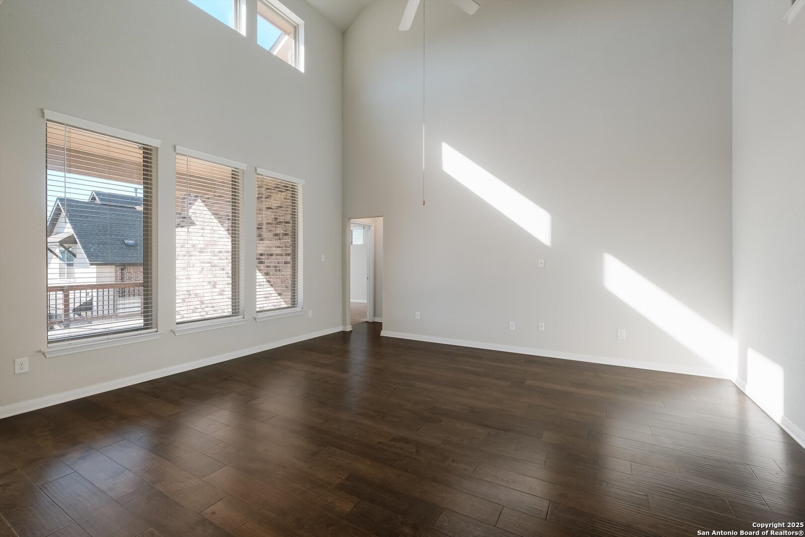 1718 Wind River San Antonio, TX 78258 - Photo 9 of 32 an empty room with wooden floor and windows