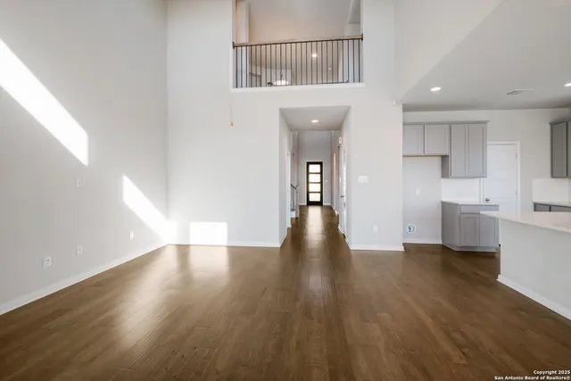 a view of a kitchen with wooden floor and a sink