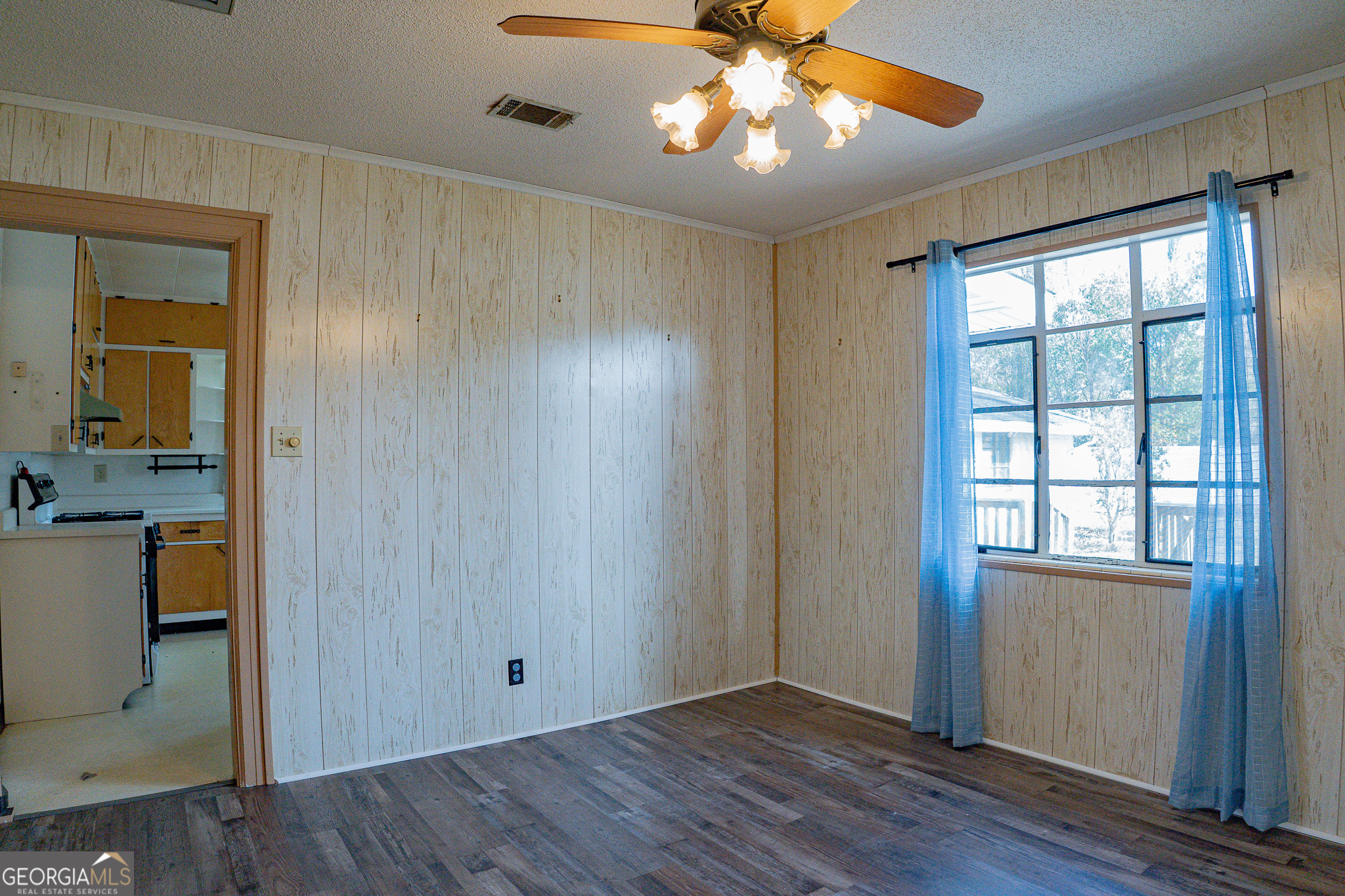 1615 Brunel Street Waycross, GA 31501 - Photo 5 of 28 wooden floor in an empty room with a window