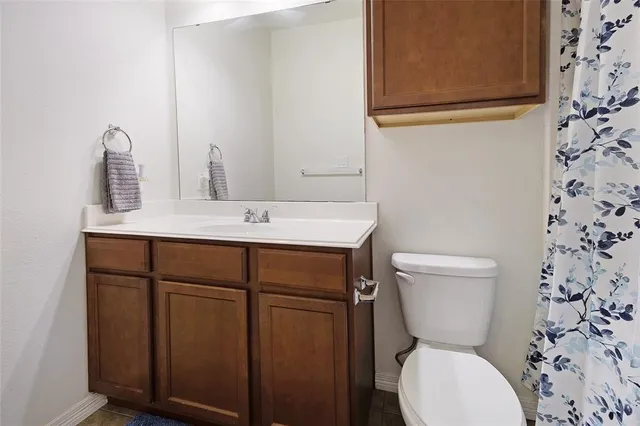 a bathroom with a sink a toilet and a mirror