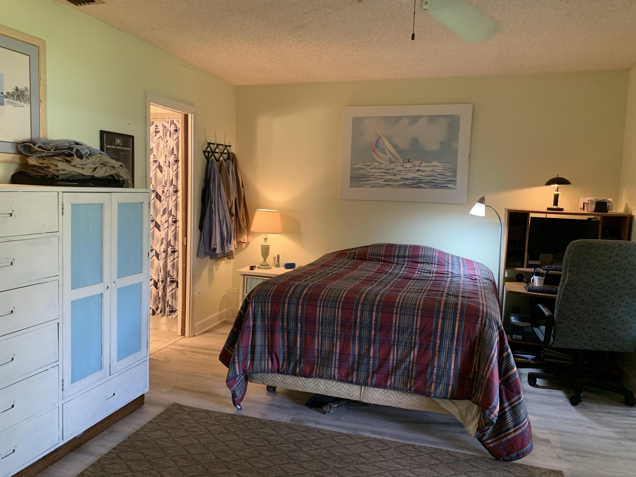 6036 Indrio Road, Unit R3 Fort Pierce, FL 34951 - Photo 10 of 24 a bedroom with a bed and a desk