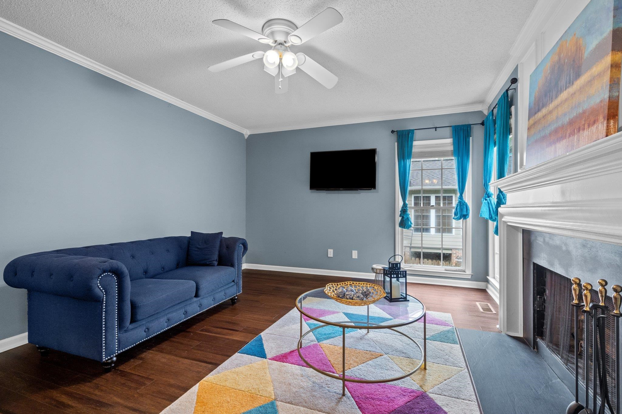 6305 Dry Fork Lane Raleigh, NC 27617 - Photo 14 of 41 a living room with furniture a fireplace and a flat screen tv