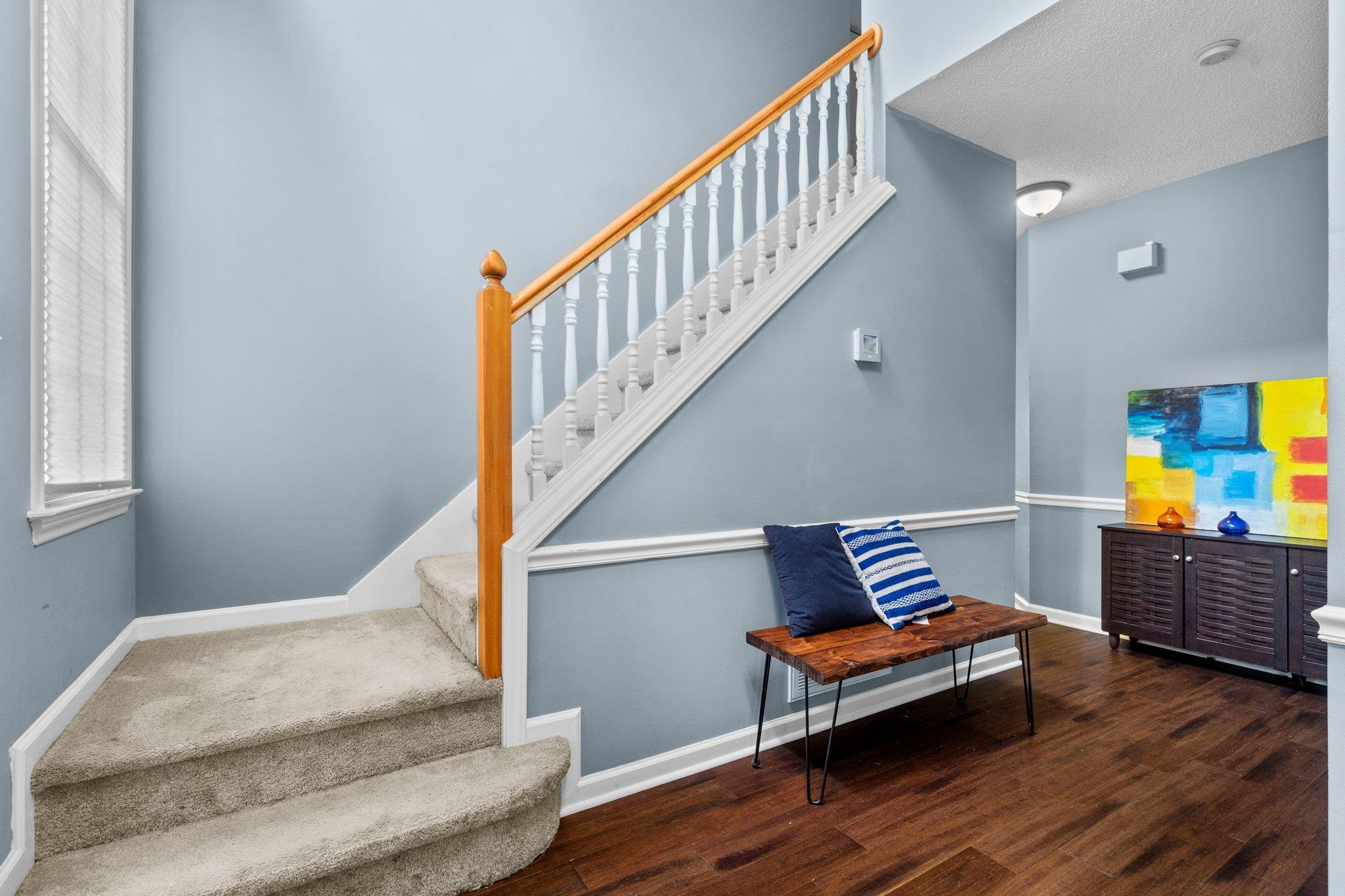 6305 Dry Fork Lane Raleigh, NC 27617 - Photo 17 of 41 a bedroom with wooden floor stairs and a furniture