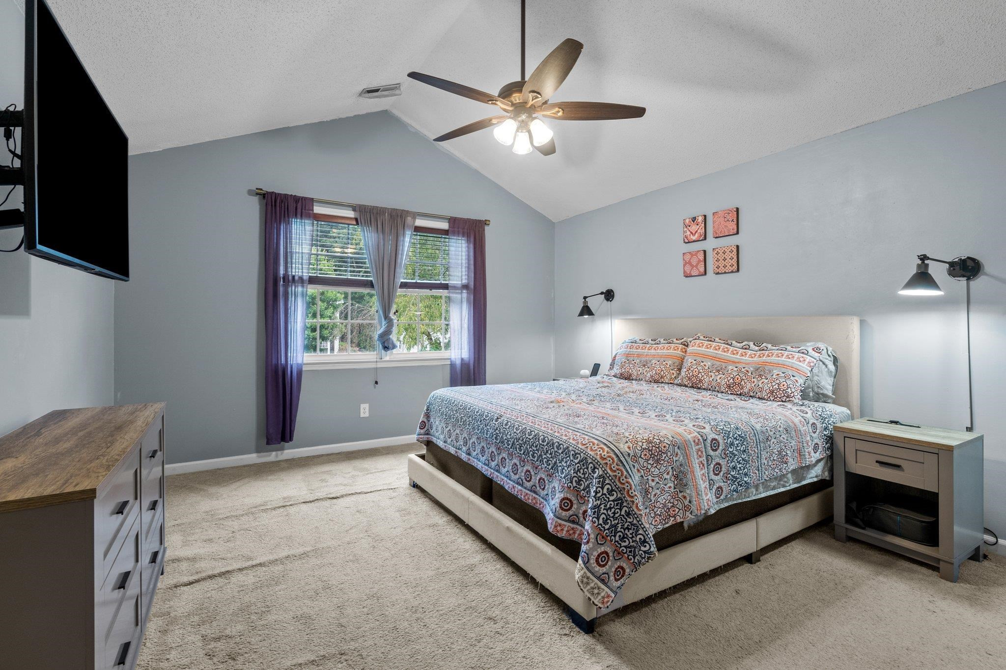 6305 Dry Fork Lane Raleigh, NC 27617 - Photo 20 of 41 a bedroom with a large bed and a window