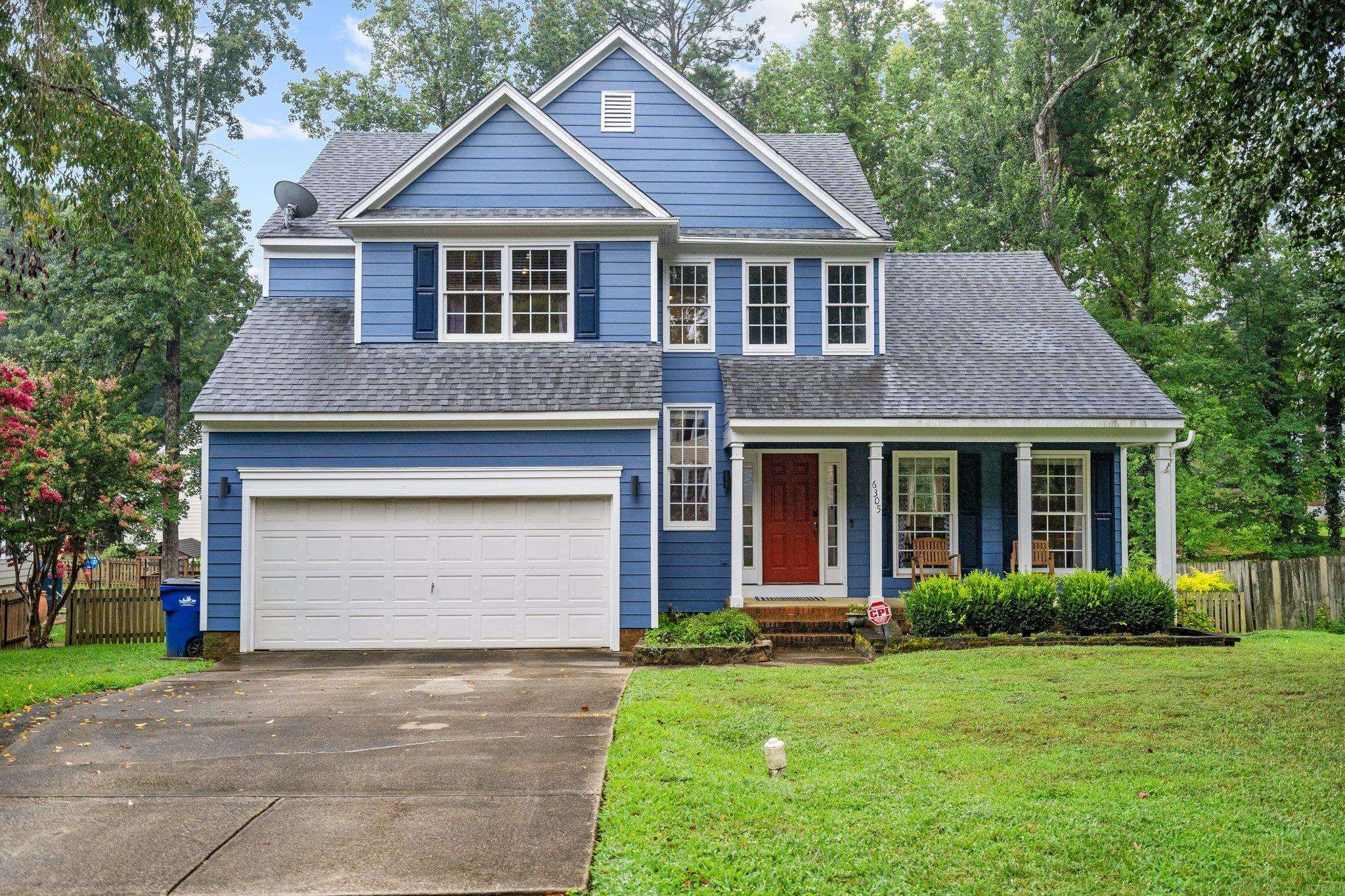 6305 Dry Fork Lane Raleigh, NC 27617 - Photo 2 of 41 a front view of a house with a yard and garage