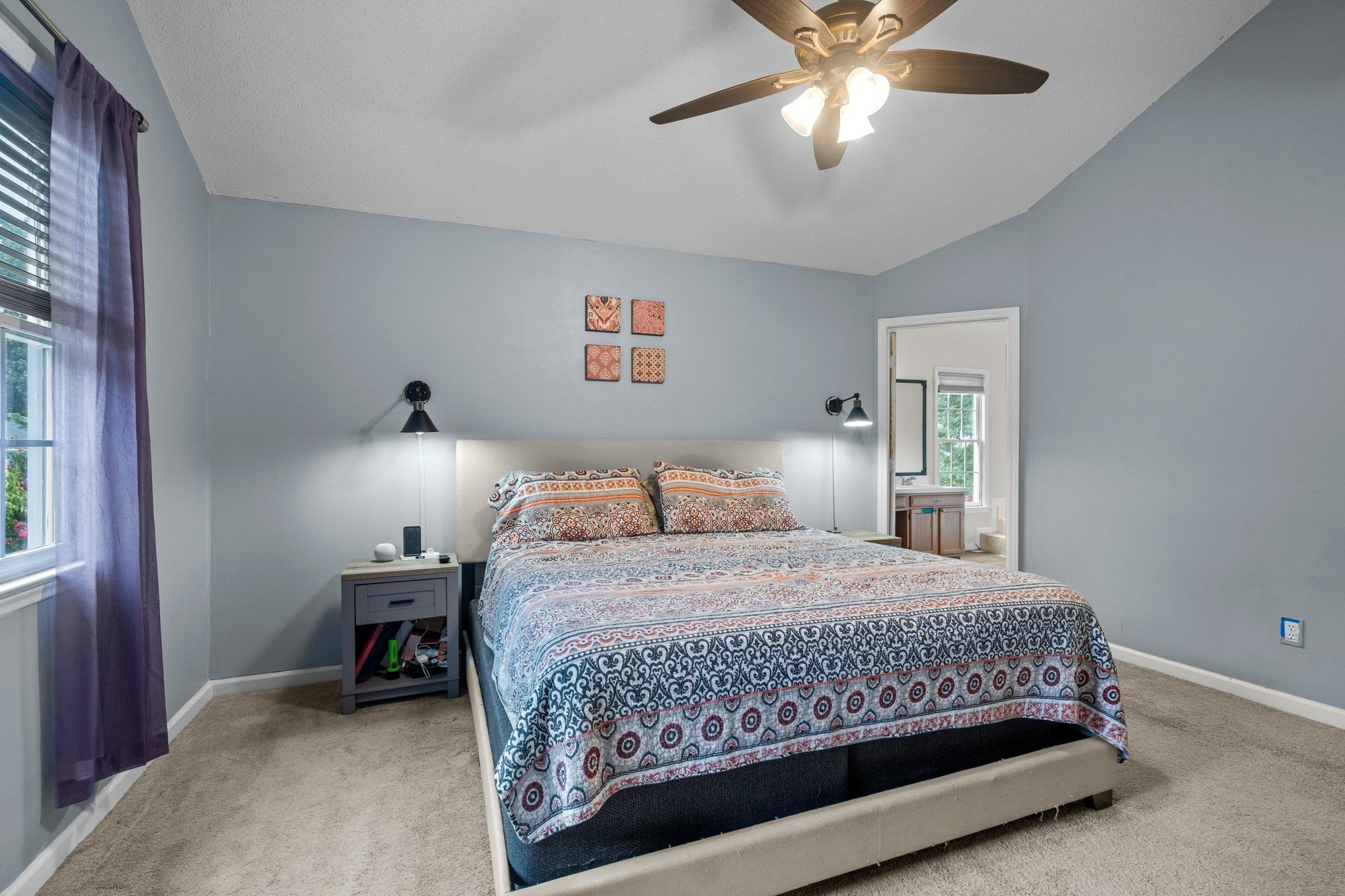 6305 Dry Fork Lane Raleigh, NC 27617 - Photo 22 of 41 a bedroom with a bed and a chandelier