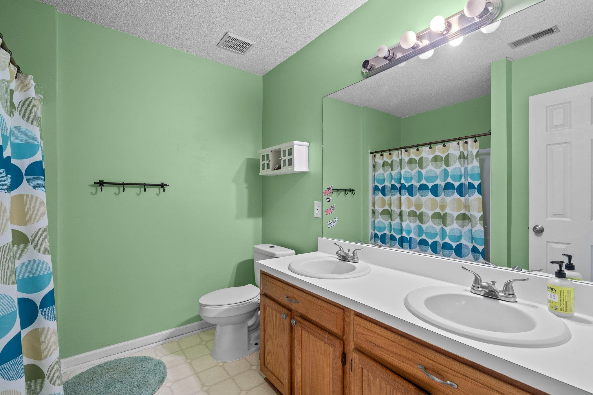 6305 Dry Fork Lane Raleigh, NC 27617 - Photo 26 of 41 a bathroom with a sink a toilet and shower