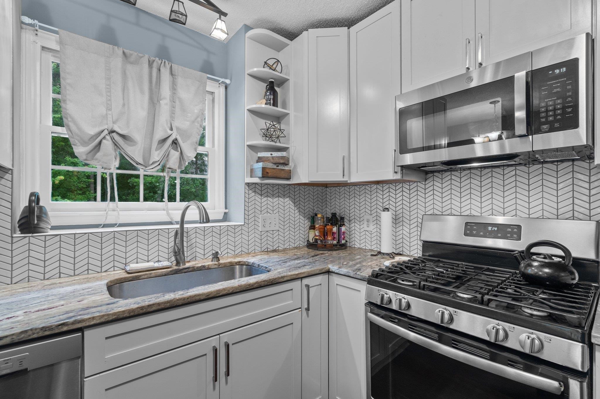 6305 Dry Fork Lane Raleigh, NC 27617 - Photo 5 of 41 a kitchen with stainless steel appliances a sink a stove and cabinets