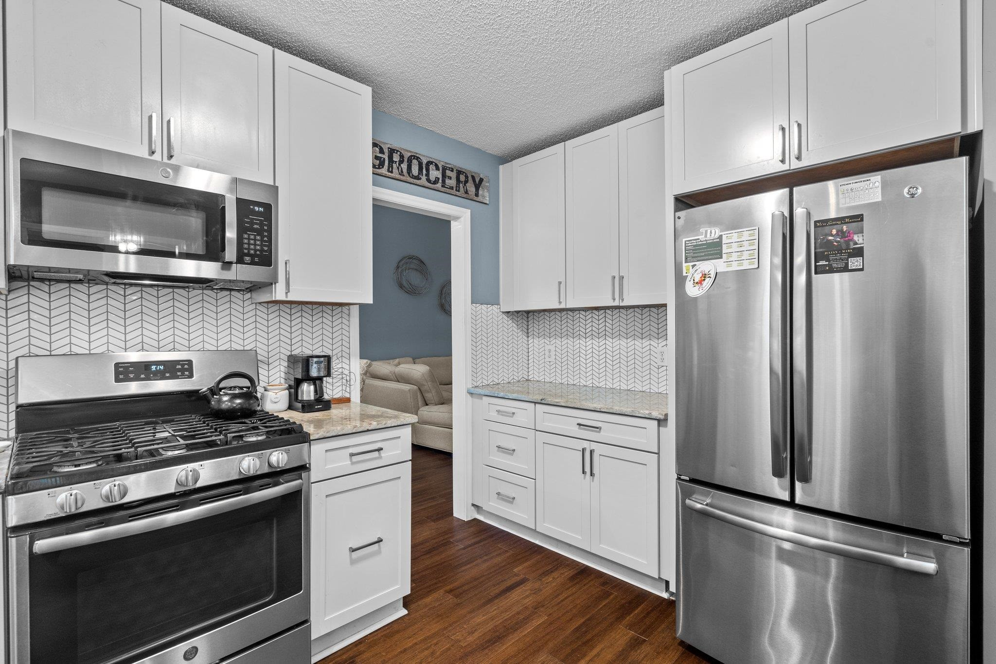 6305 Dry Fork Lane Raleigh, NC 27617 - Photo 6 of 41 a kitchen with stainless steel appliances white cabinets white stove a refrigerator and a microwave