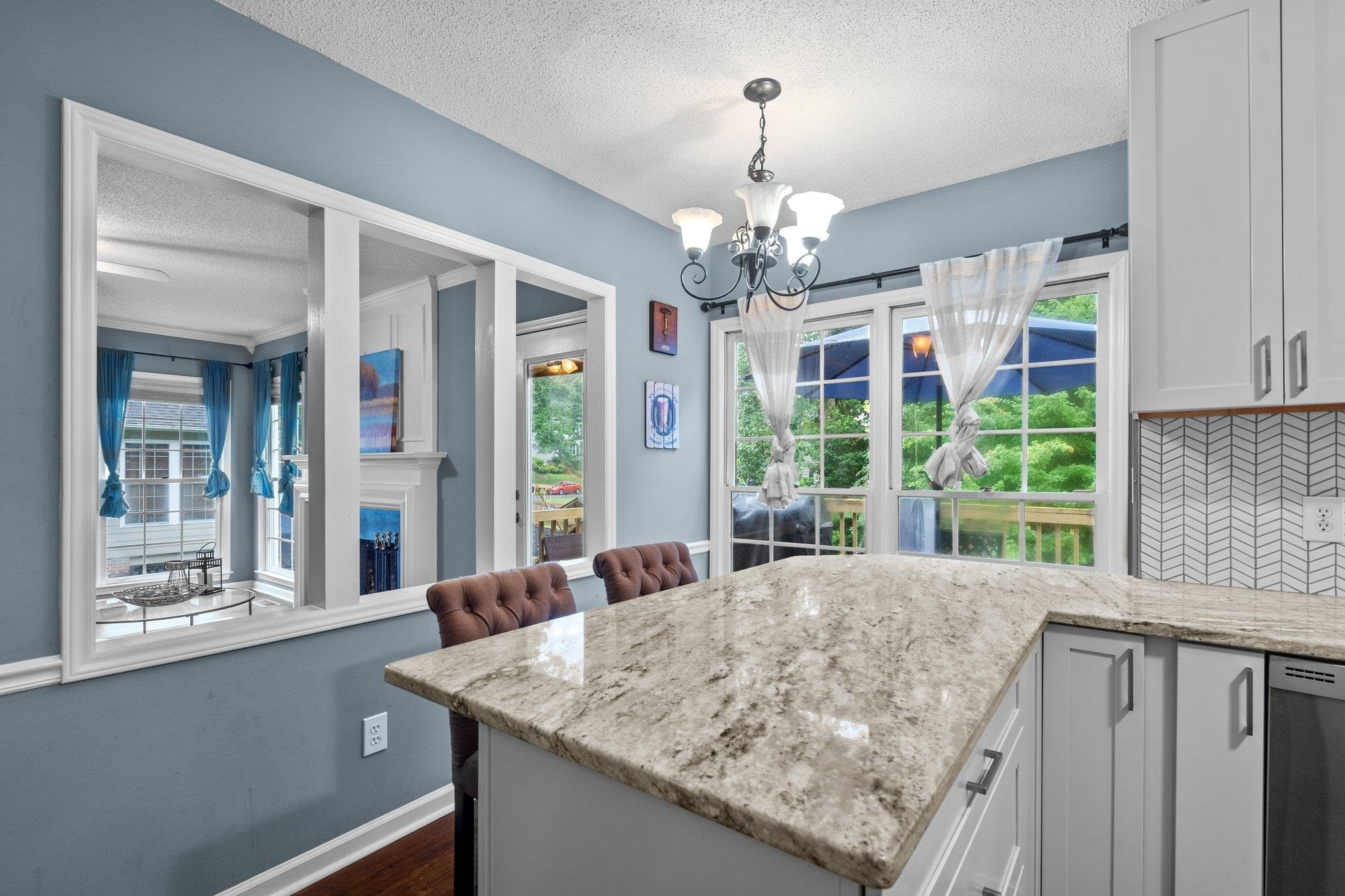 6305 Dry Fork Lane Raleigh, NC 27617 - Photo 7 of 41 a view of a kitchen with granite countertop a sink and dishwasher with large windows