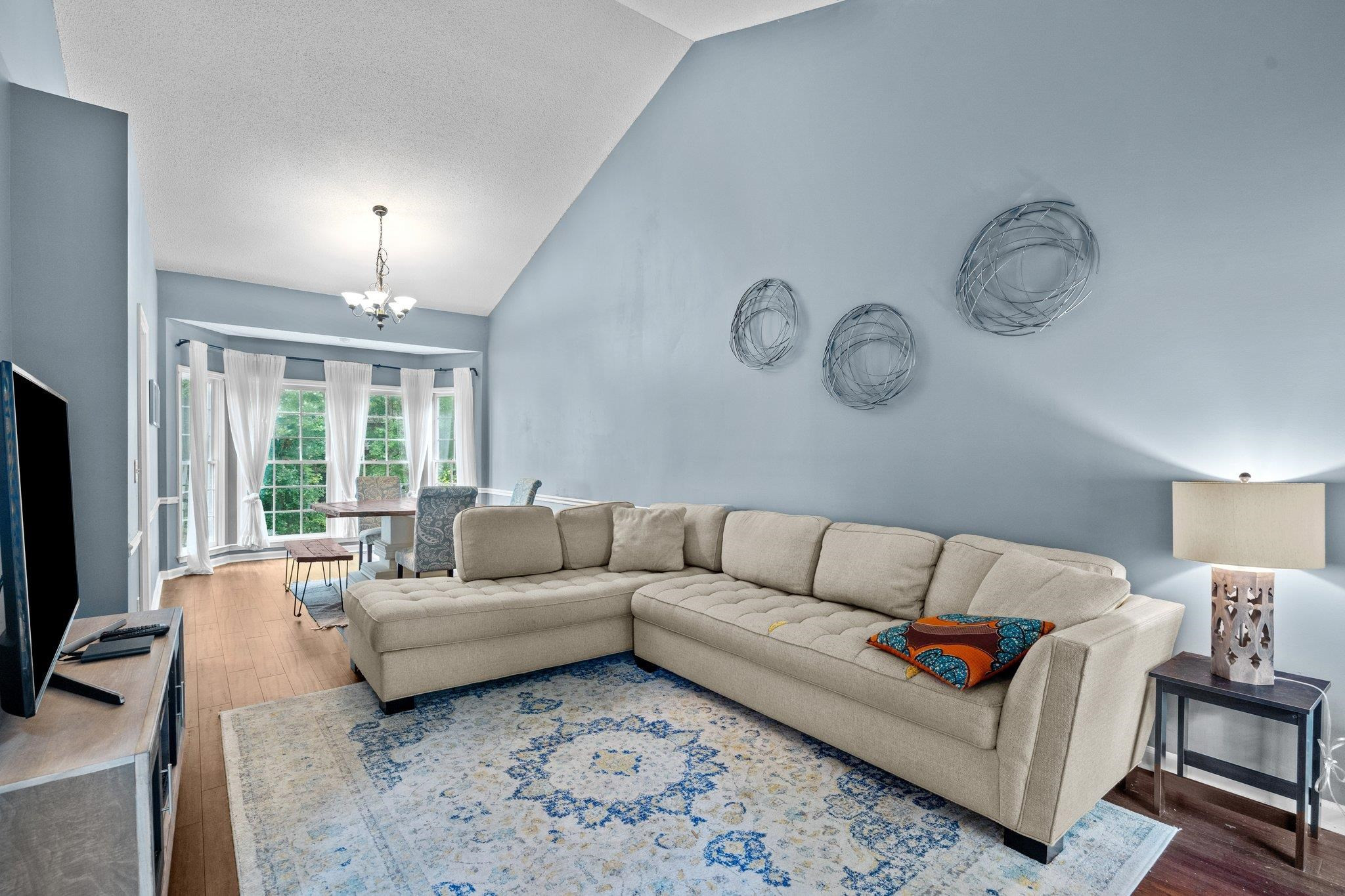 6305 Dry Fork Lane Raleigh, NC 27617 - Photo 8 of 41 a living room with furniture ceiling fan and a large window