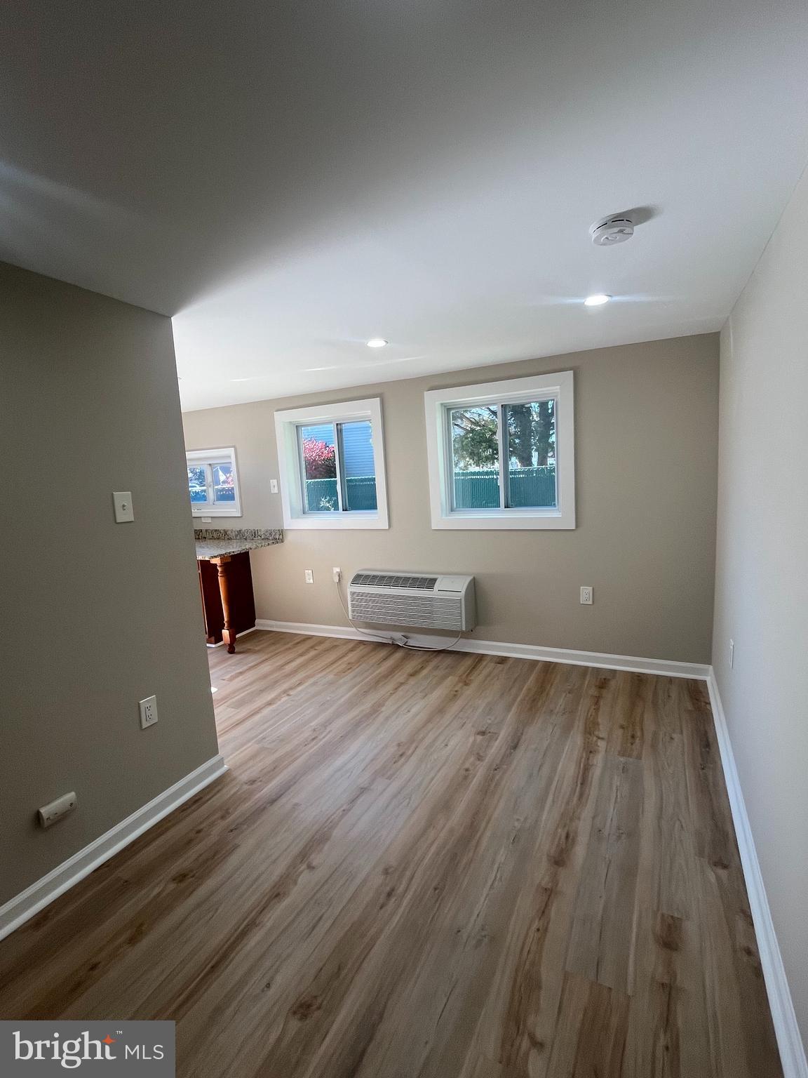 1881 Williamstown Road Sicklerville, NJ 08081 - Photo 3 of 13 an empty room with wooden floor and windows