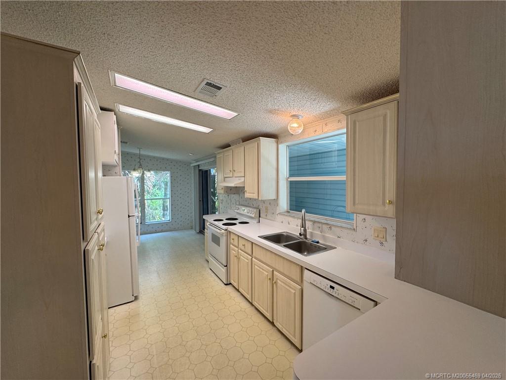 4236 Southeast Sweetwood Way Stuart, FL 34997 - Photo 11 of 50 a kitchen with stainless steel appliances granite countertop a refrigerator and a stove