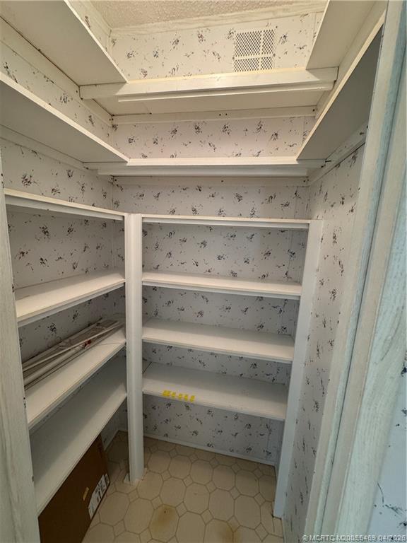 4236 Southeast Sweetwood Way Stuart, FL 34997 - Photo 13 of 50 a view of an empty walk in closet